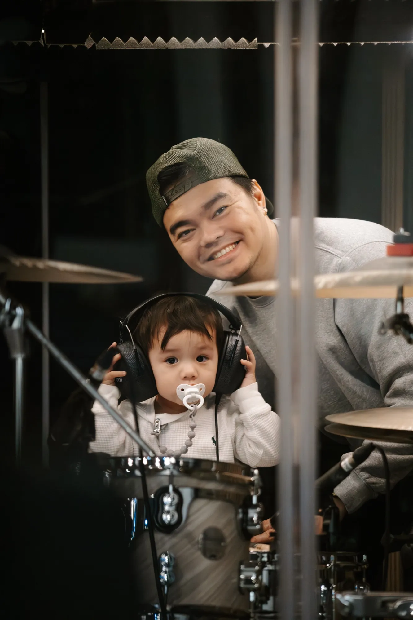A dad and his small child at the drum set