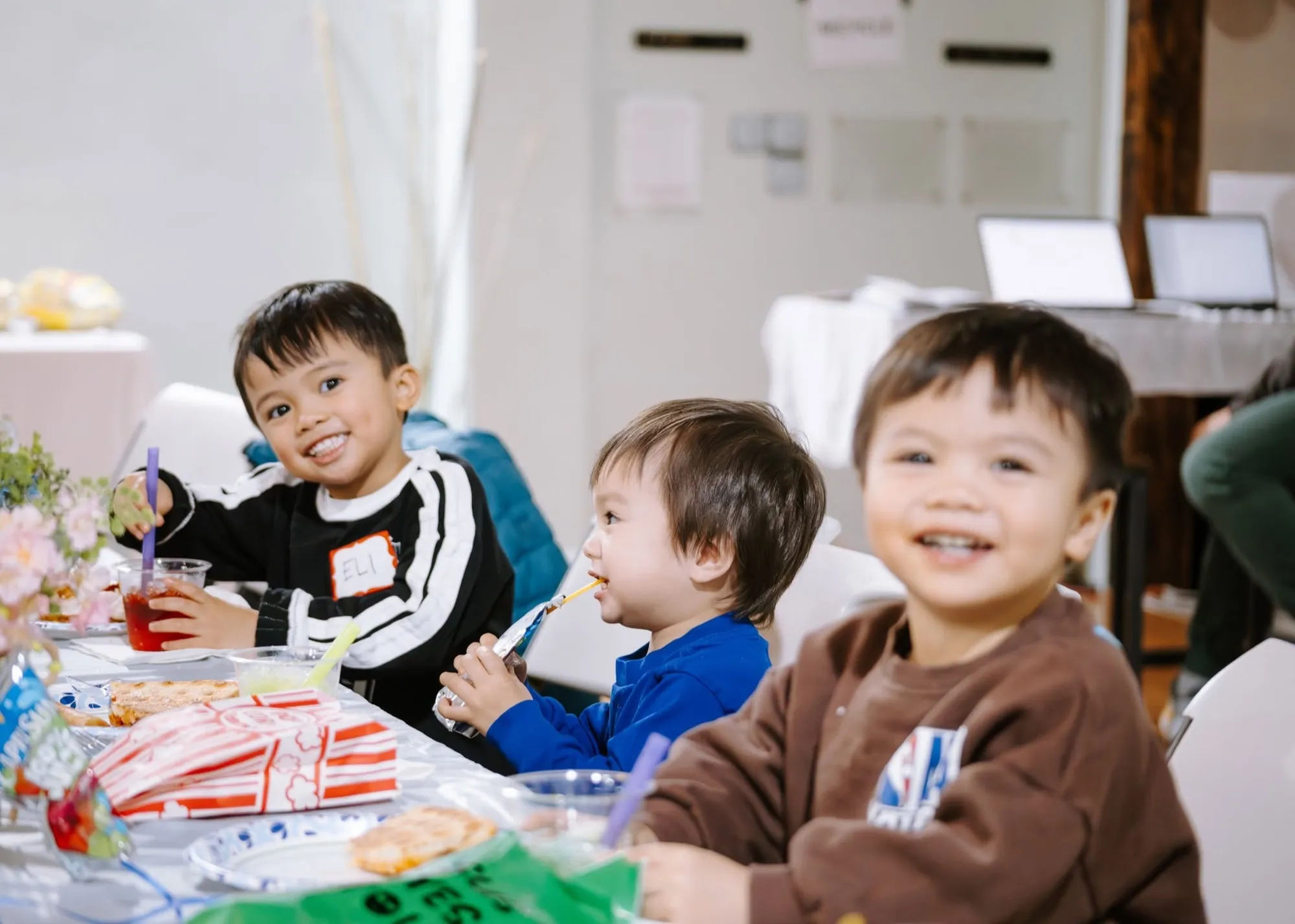 Young kids smiling around a table